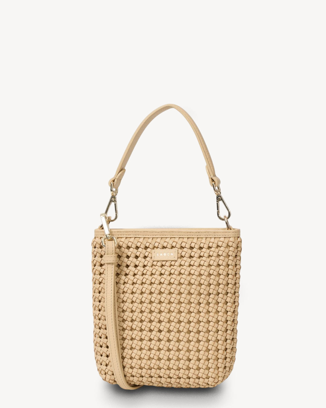 Beige woven handbag with a strap on a white background