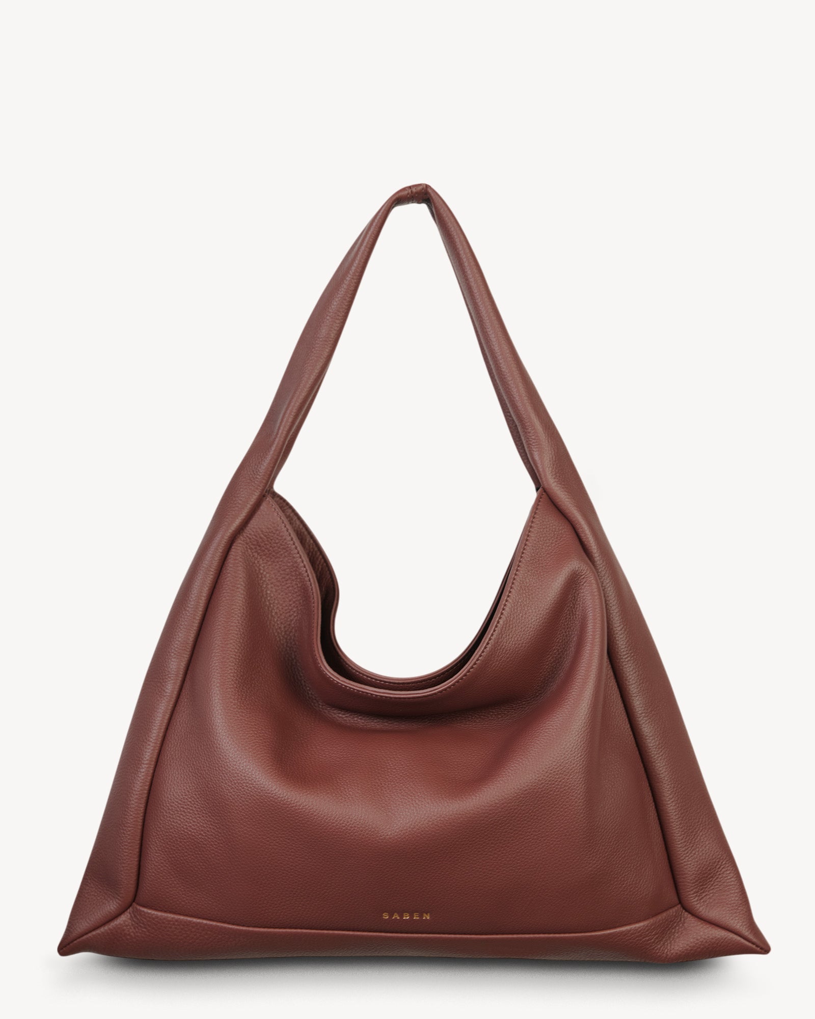 Brown leather handbag on a light gray background