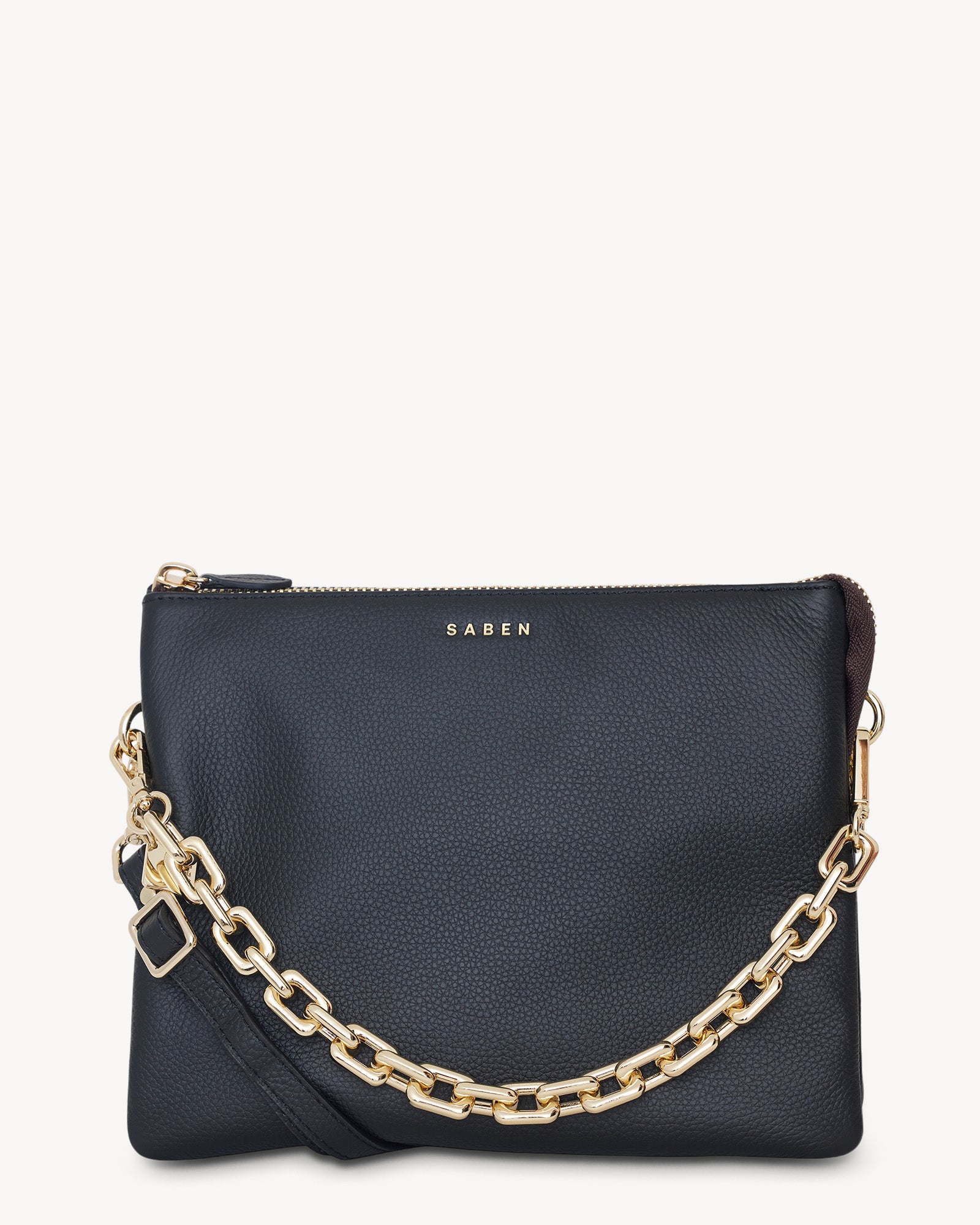A Black crossbody bag with a chunky gold chain handle and a zip top closure, featuring a Saben brand logo.