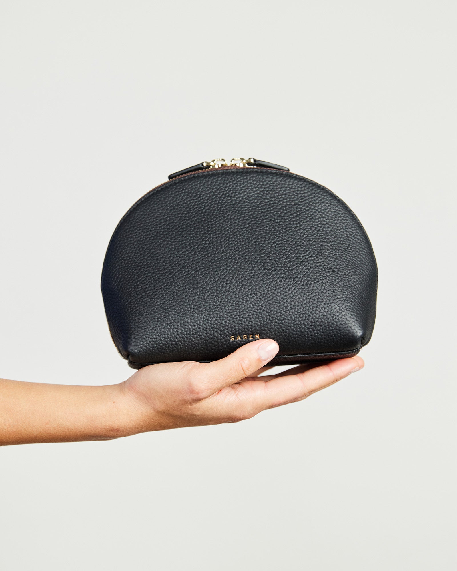 A black cosmetic pouch with a chain pattern, featuring a top zip closure and displayed against a plain background.