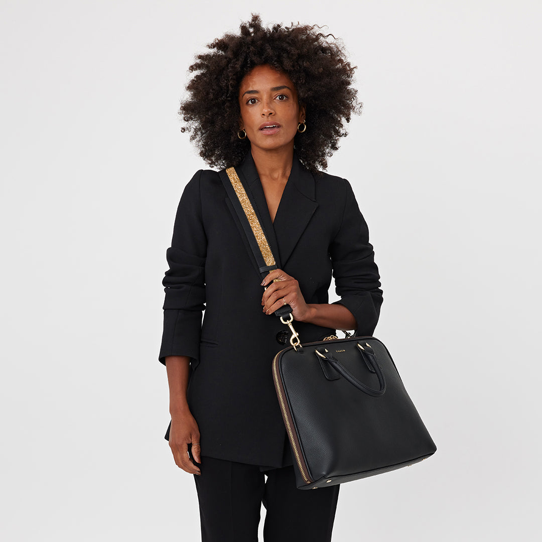 Strap with gold and black fabric design on a white background