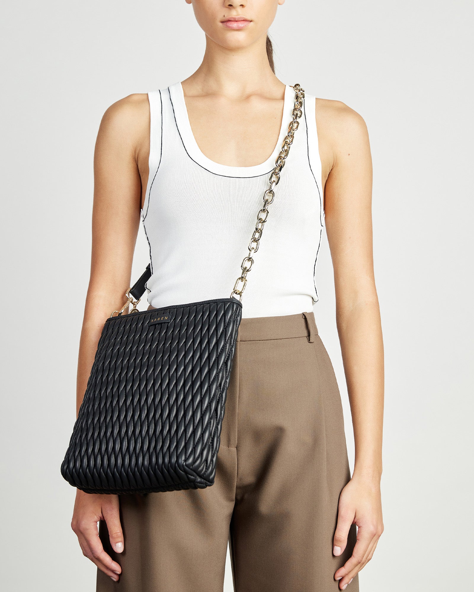 A detachable and adjustable black leather chain strap with gold curb links and hardware.