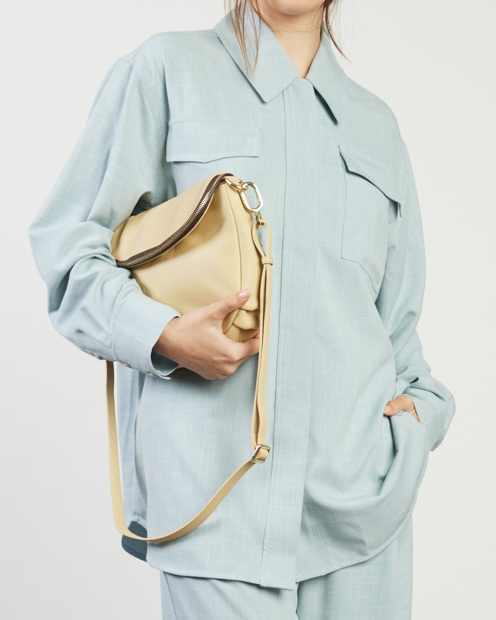 Beige handbag with a zipper on a white background