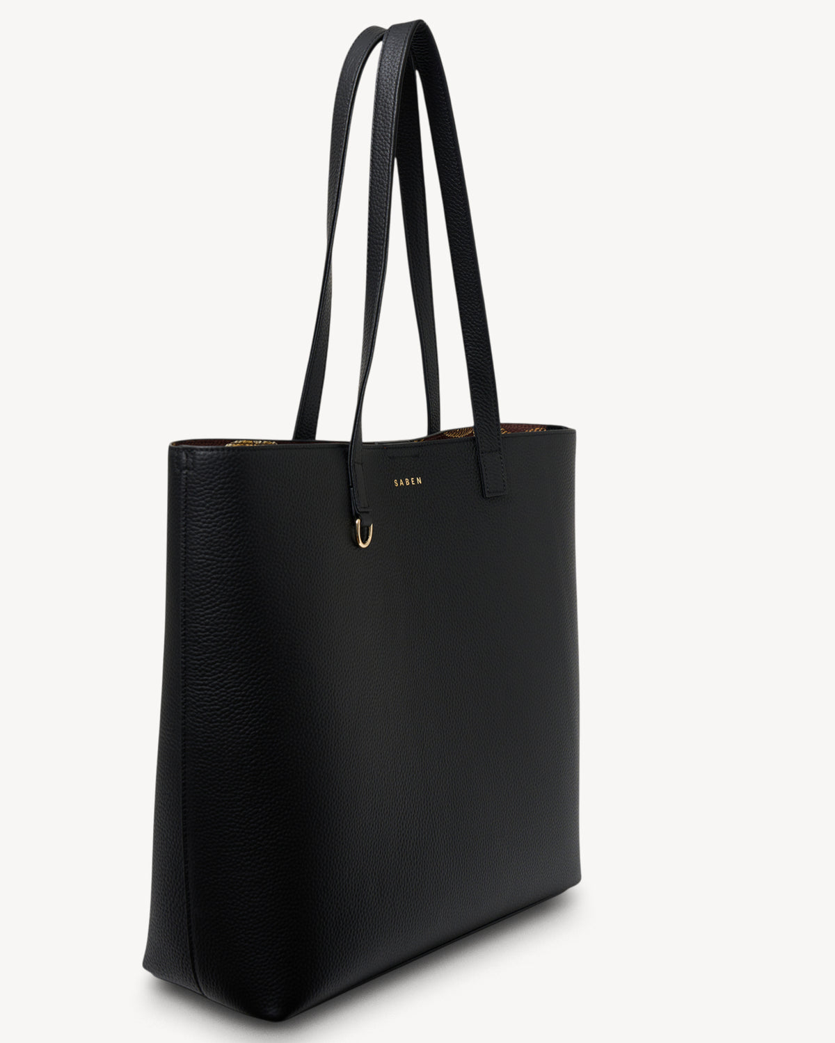 Black tote bag with gold hardware on a white background
