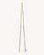 Gold chain necklace on a light beige background