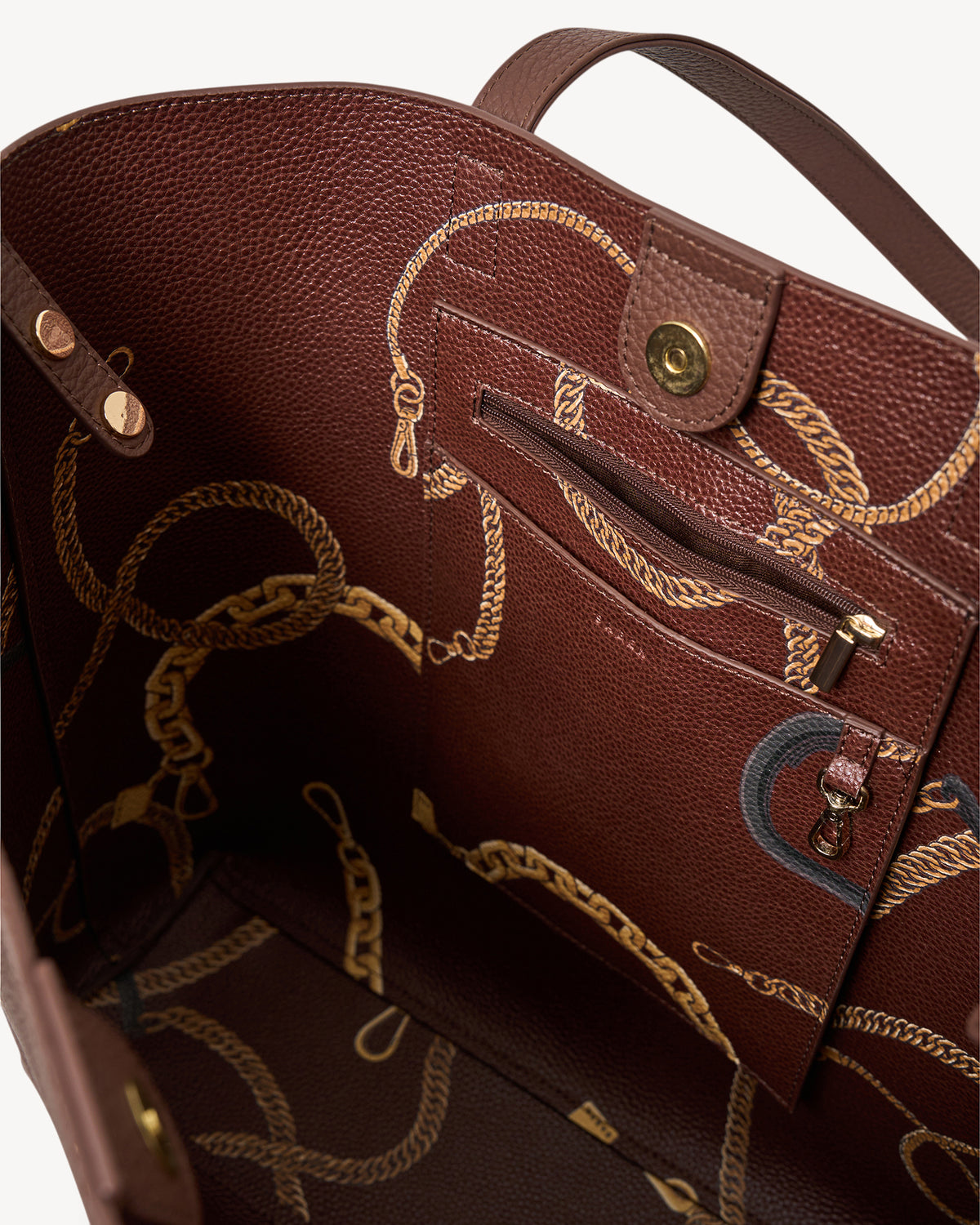 Brown leather handbag with gold chain details on a white background