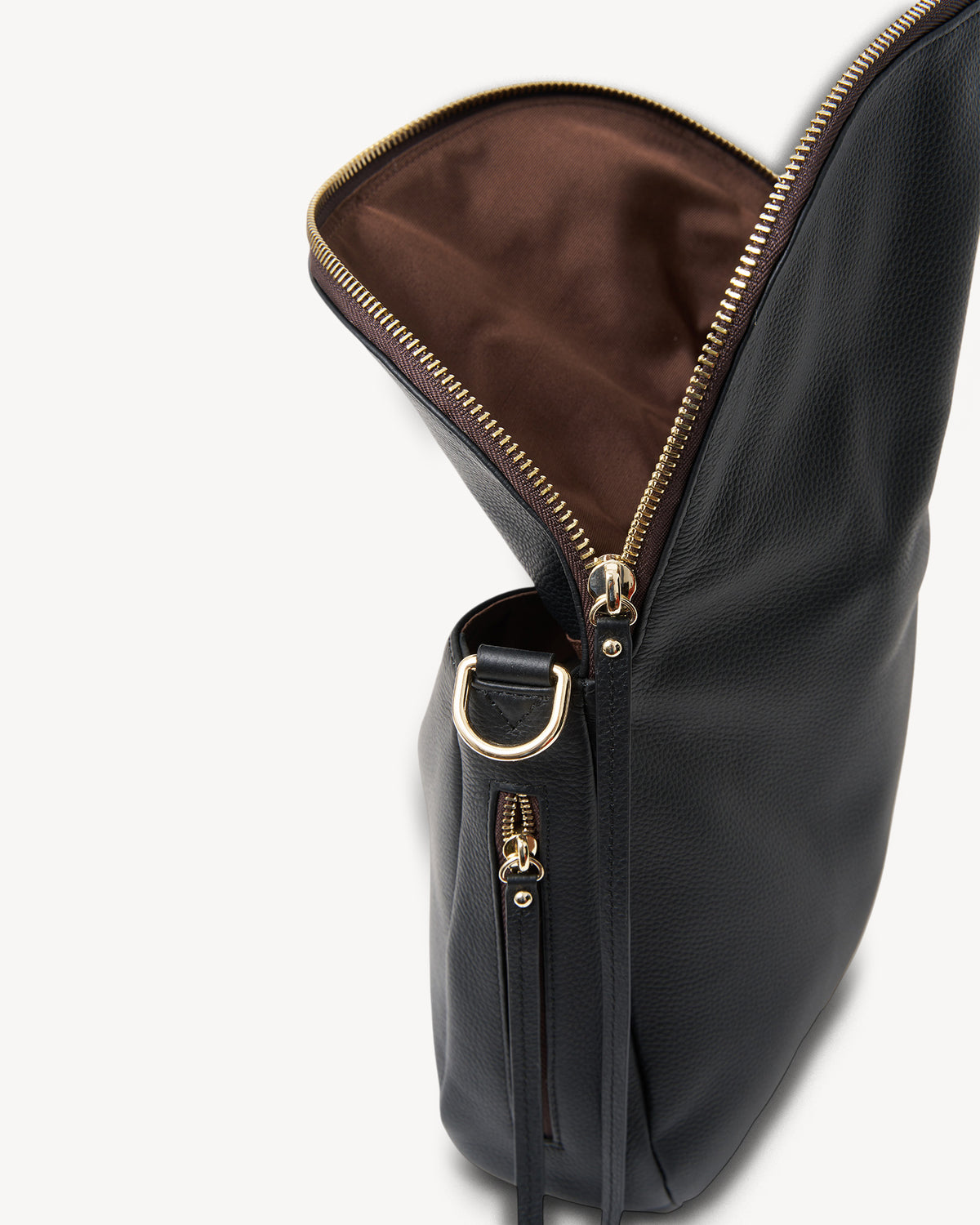 Black leather handbag with gold zipper on a white background