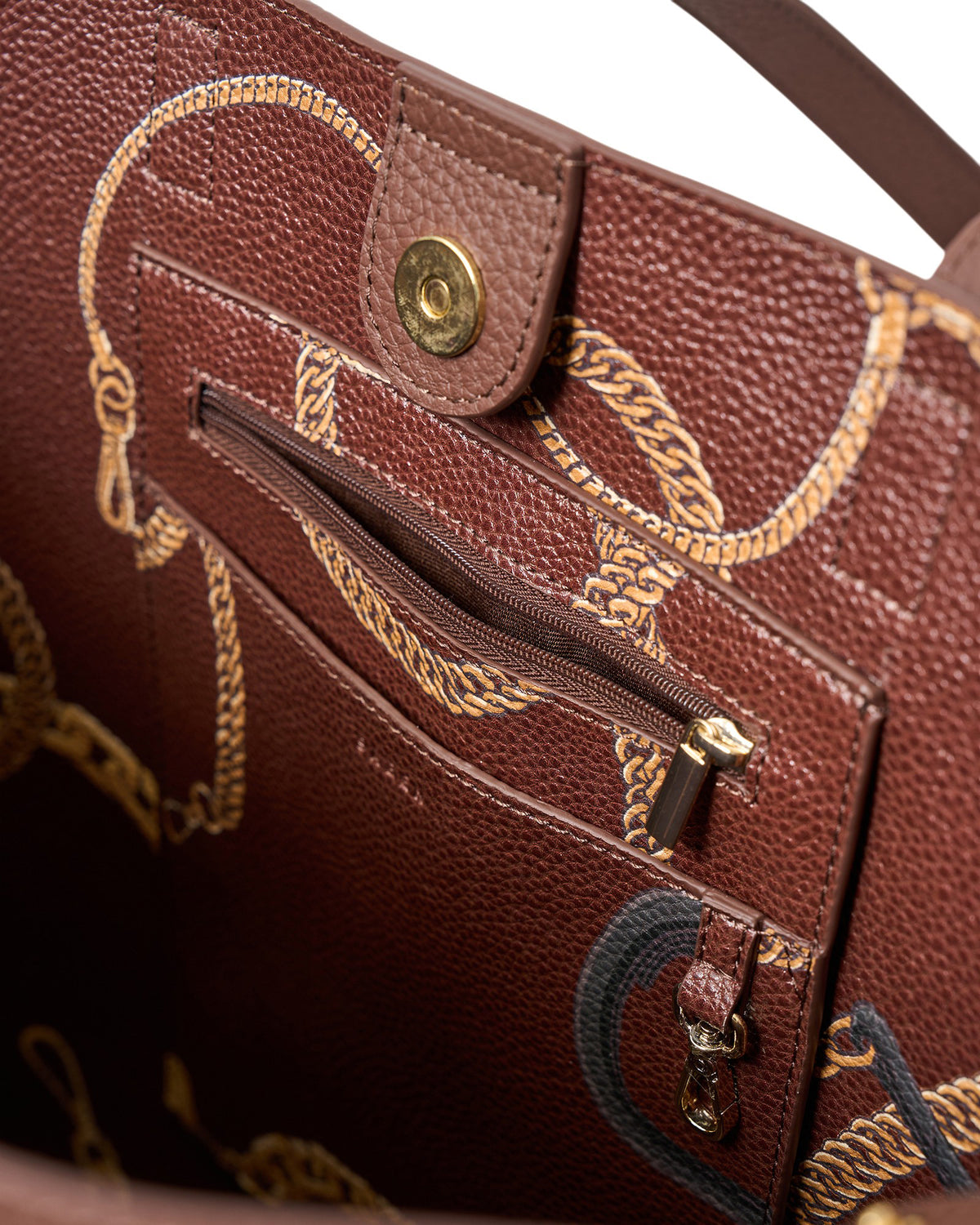 Close-up of a brown leather handbag with gold accents