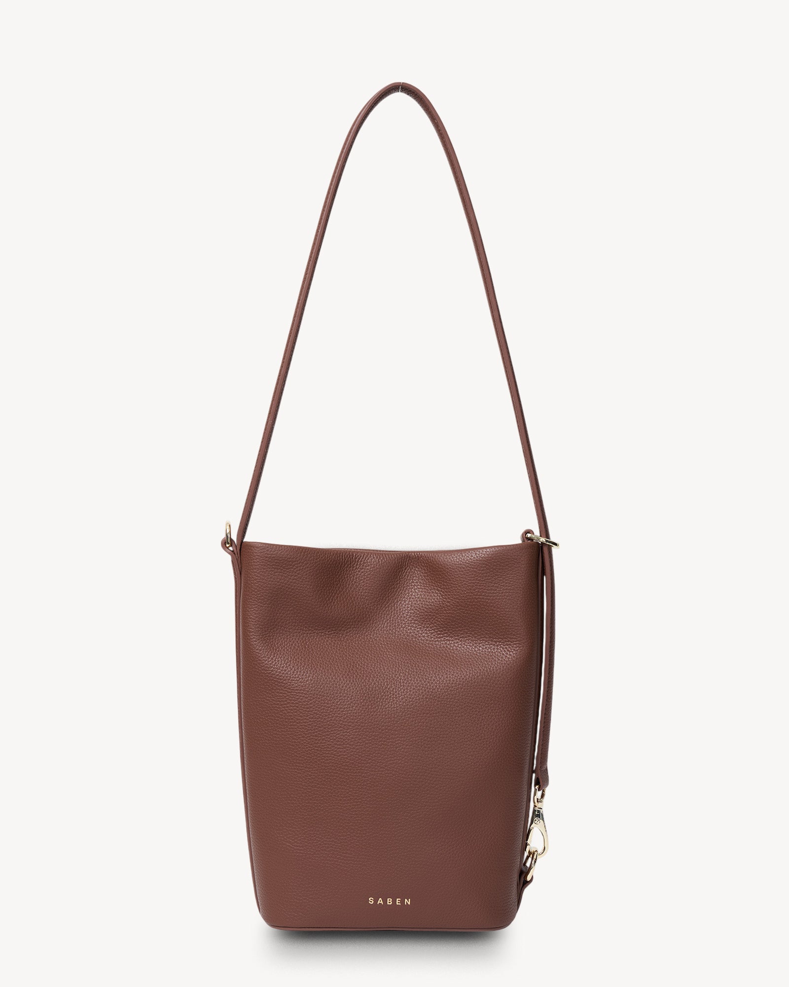 Brown leather handbag with a shoulder strap on a light gray background