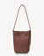 Brown leather handbag with a shoulder strap on a light gray background