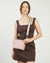 Strap with pink and white pattern on a beige background