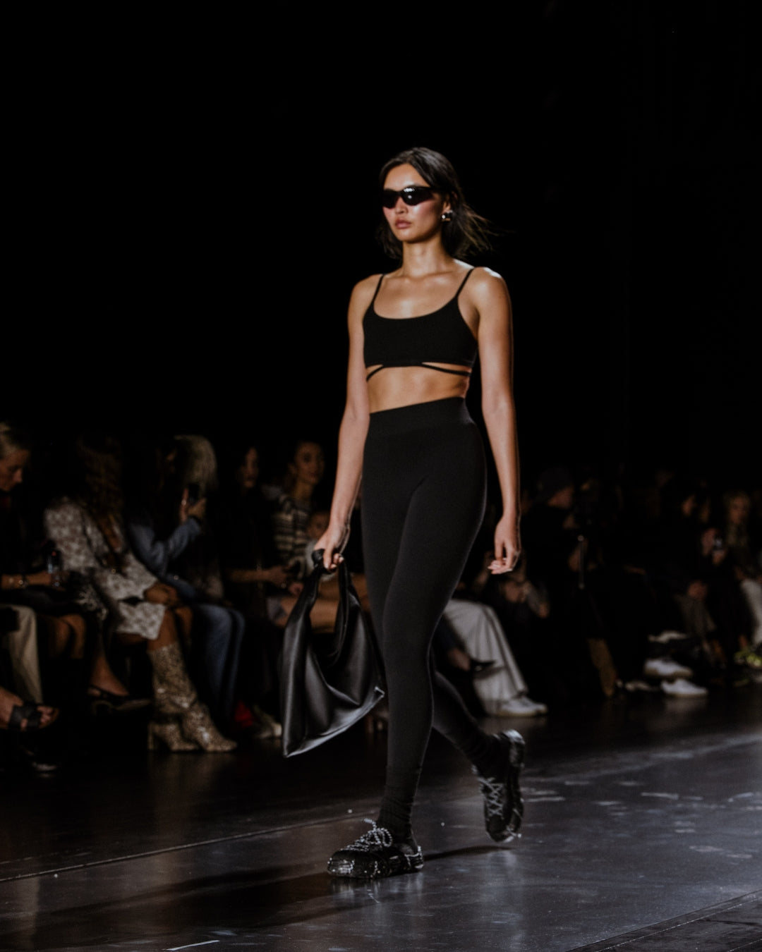 Black leather handbag on a light gray background