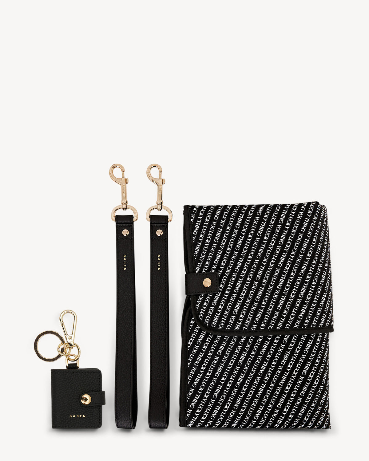 Black and white patterned pouch with keychain and strap on a white background