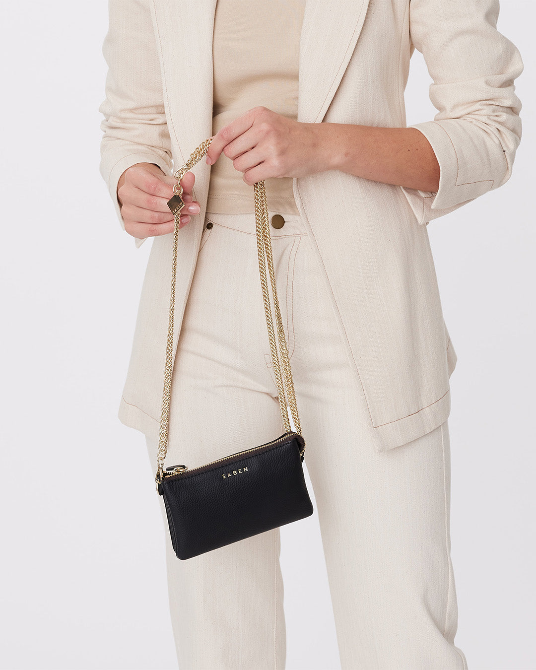 A detachable and adjustable starp with gold curb links and hardware.