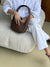 Brown handbag on a light beige background