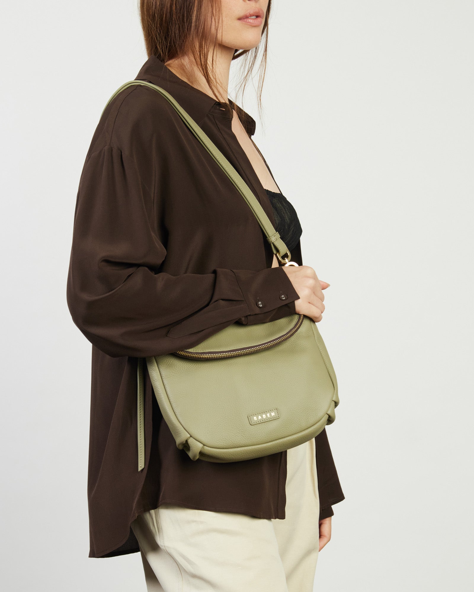 Green handbag with a visible brand logo on a white background