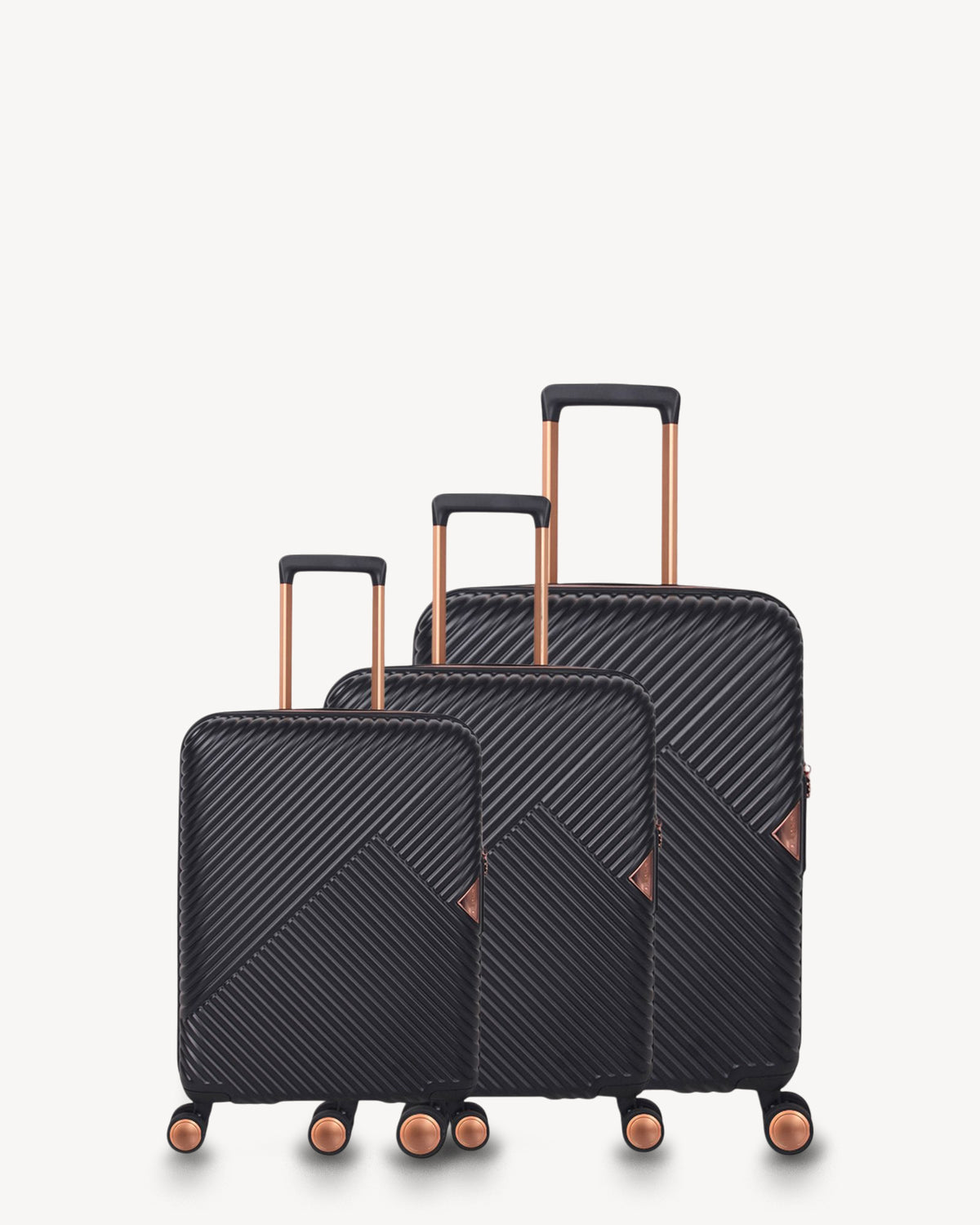 Set of three black suitcases with rose gold handles and wheels on a white background