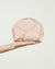 Pink cosmetic bag with gold chain design on a white background