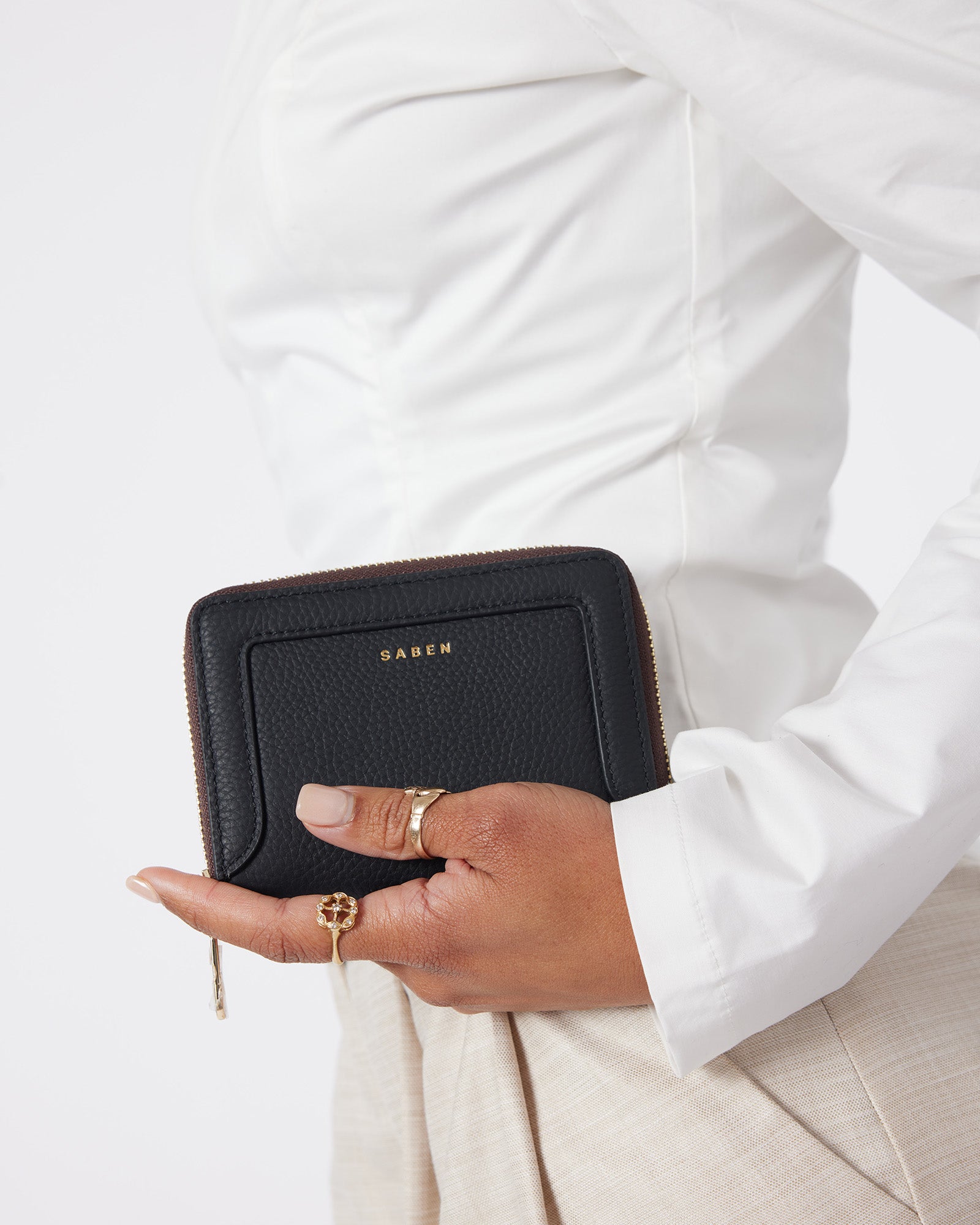 Black wallet with 'Saben' branding on a white background
